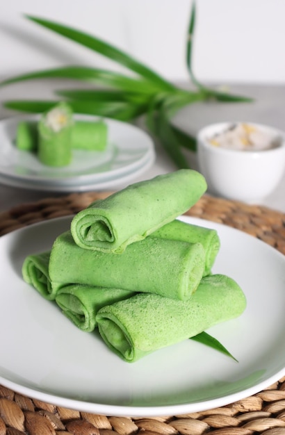 Dadar Gulung or Dadar Unti is Indonesian finger food is grated coconut sweetened with palm sugar