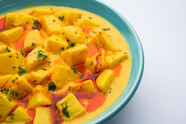 Dahi wale aloo or aaloo or yogurt or curd potato curry an indian classical dish served in bowl with naan selective focus