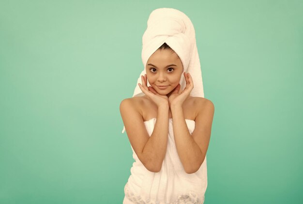 Daily skin care routine healthy childhood kid in terry towel after bath beauty day in spa