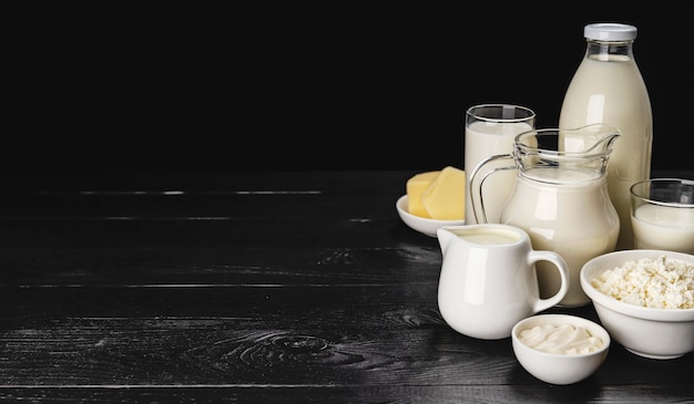 Dairy products on black wooden surface