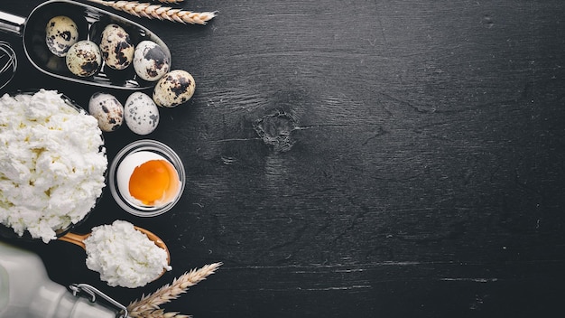 Dairy products Cheese cottage cheese milk sour cream on a black wooden background Top view Free space