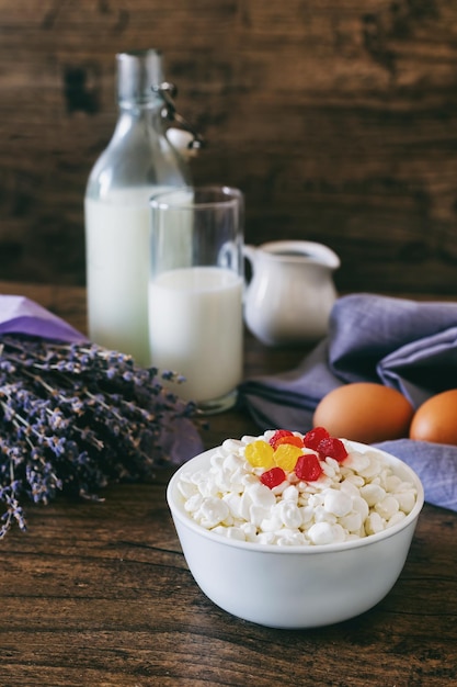 Dairy products on dark wooden table sour cream milk cheese egg selective focus