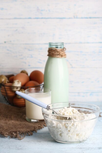 Dairy products and fresh eggs on wooden background