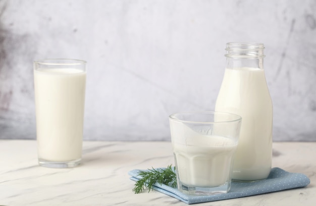 Dairy products, health concept, in glassware, on a light gray background.