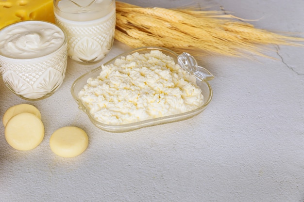 Dairy products with wheat on white surface