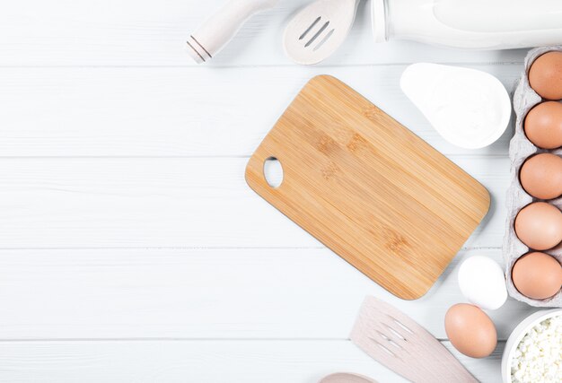 Dairy products on wooden table, top view