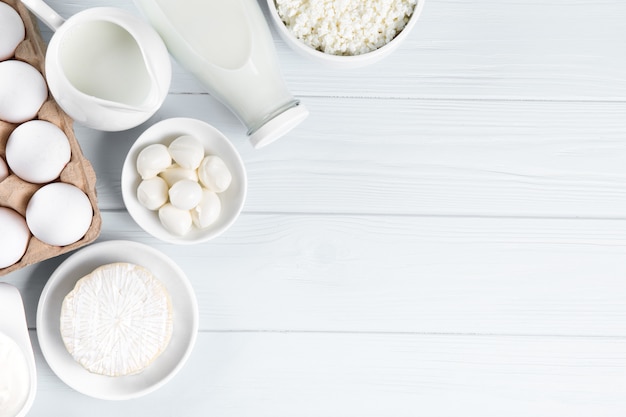 Dairy products on wooden table, top view