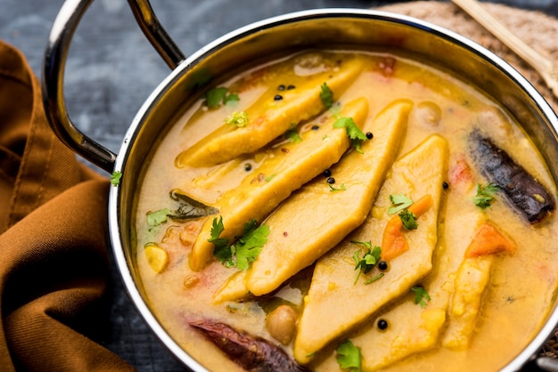 Dal Dhokli, Varan Phal or Chakolya is a gujarati, Rajasthani and maharashtrian dish made using diamond shape wheat flour cakes boiled in a dal. It's an easy one pot meal. served in a bowl.