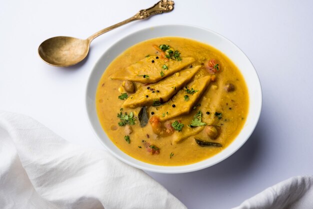 Dal Dhokli, Varan Phal or Chakolya is a gujarati, Rajasthani and maharashtrian dish made using diamond shape wheat flour cakes boiled in a dal. It's an easy one pot meal. served in a bowl.