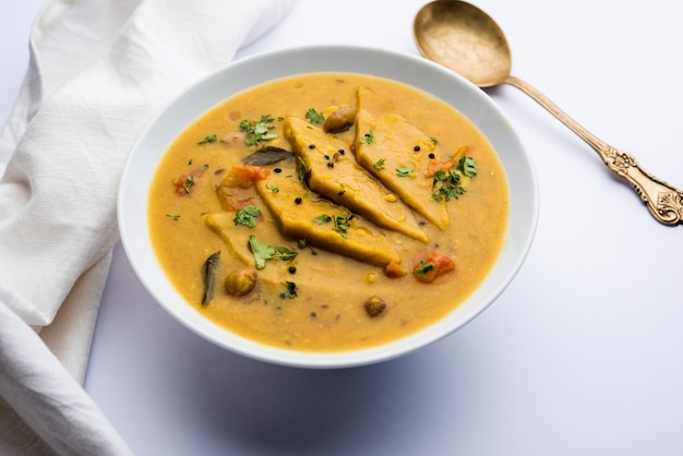 Dal Dhokli, Varan Phal or Chakolya is a gujarati, Rajasthani and maharashtrian dish made using diamond shape wheat flour cakes boiled in a dal. It's an easy one pot meal. served in a bowl.