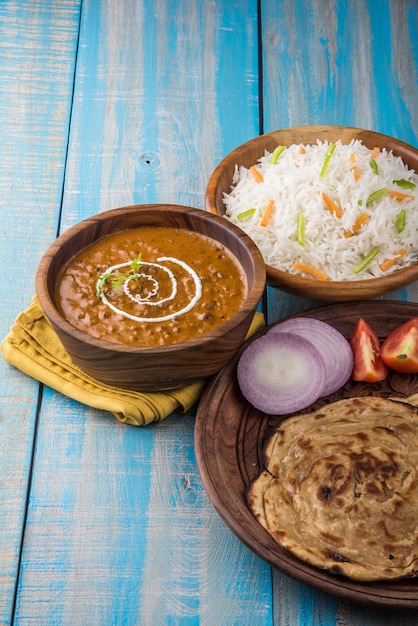 Dal Makhani or daal makhni, indian lunch or dinner item served with plain rice and butter Roti or Chapati or Paratha and salad