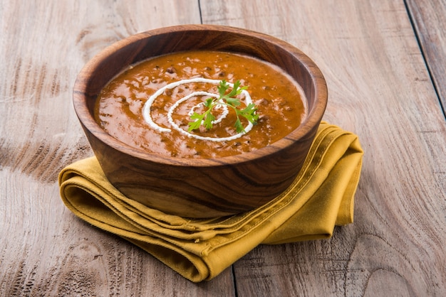 Dal Makhani or daal makhni, indian lunch or dinner item served with plain rice and butter Roti or Chapati or Paratha and salad