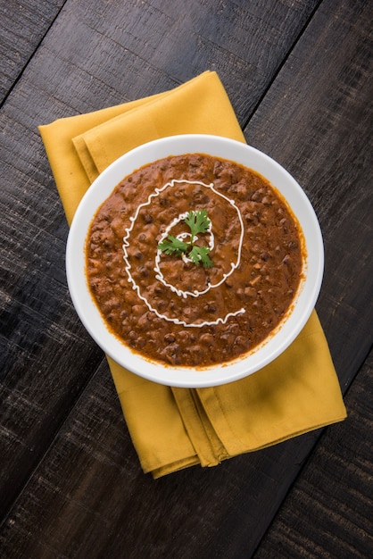 Dal Makhani or daal makhni, indian lunch or dinner item served with plain rice and butter Roti or Chapati or Paratha and salad