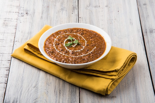 Dal Makhani or daal makhni, indian lunch or dinner item served with plain rice and butter Roti or Chapati or Paratha and salad