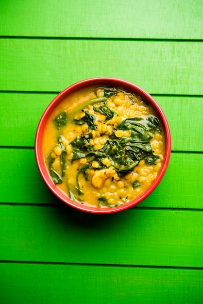 Dal Palak or Lentil spinach curry - popular Indian main course healthy recipe. served in a karahi or pan or bowl. selective focus