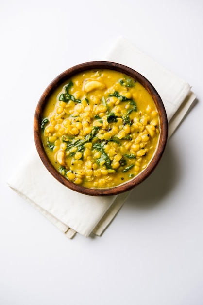 Dal Palak or Lentil spinach curry - popular Indian main course healthy recipe. served in a karahi or pan or bowl. selective focus