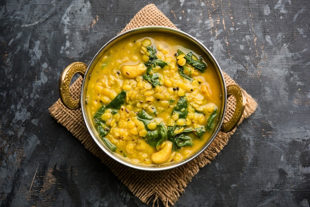 Dal Palak or Lentil spinach curry - popular Indian main course healthy recipe. served in a karahi or pan or bowl. selective focus