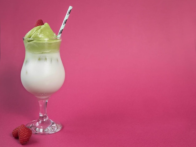 Dalgona matcha  and raspberries  on a pink background  Trendy drink  Superfoods  Dairy beverage