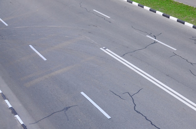 Damaged bad asphalt road with potholes