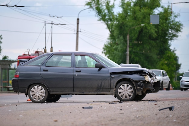 Поврежденный в автокатастрофе автомобиль на месте аварии на городской улице