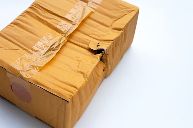 Damaged cardboard box with hole on white