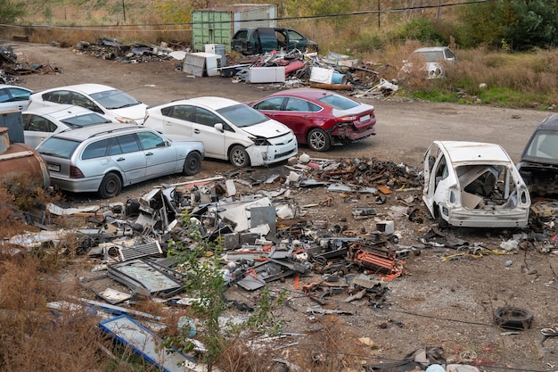 Damaged cars on the junkyard discarded old cars Outdoor