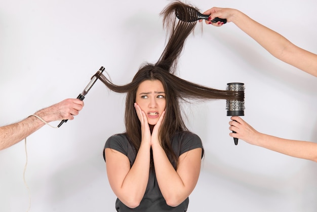 damaged hair concept, unhappy girl with her long dry hair ends and damaged hair, isolated