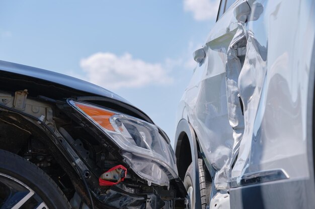 Damaged in heavy car accident vehicles after collision on city street crash site Road safety and insurance concept