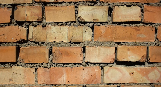 Damaged orange brickwork Orange brick horizontal dilapidated weathered Old brick wall