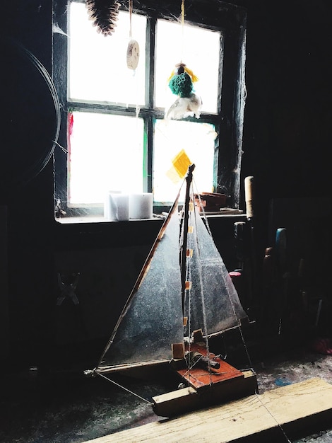 Damaged sailboat model in abandoned room