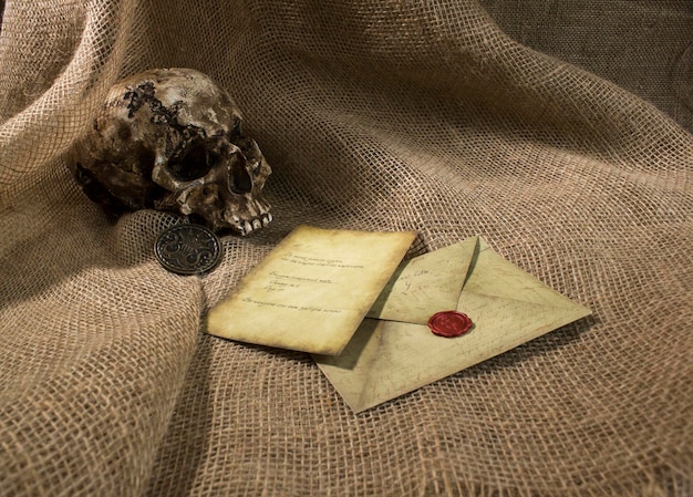 Damaged skull with a letter with a burlap background