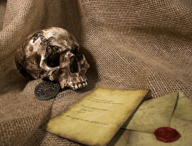 Damaged skull with a letter with a burlap background