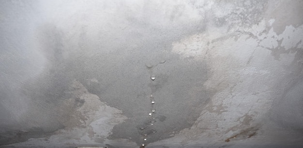 Dampness moisture on ceiling with drops of water infiltration