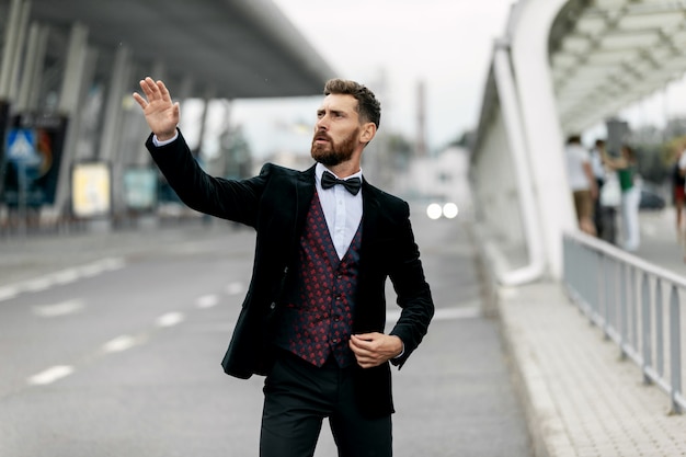 Dance success. Successful confident businessman celebrates his success. Young man formal wear his hands up and rejoice.