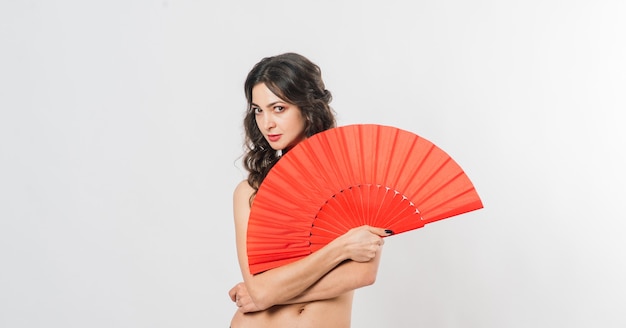 Dancer female with a fan in lingerie