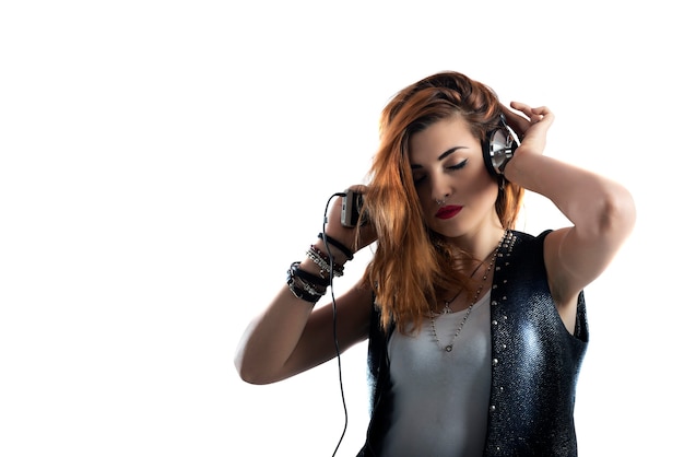 Dancing girl listens to music with headset and smartphone. isolated on white background