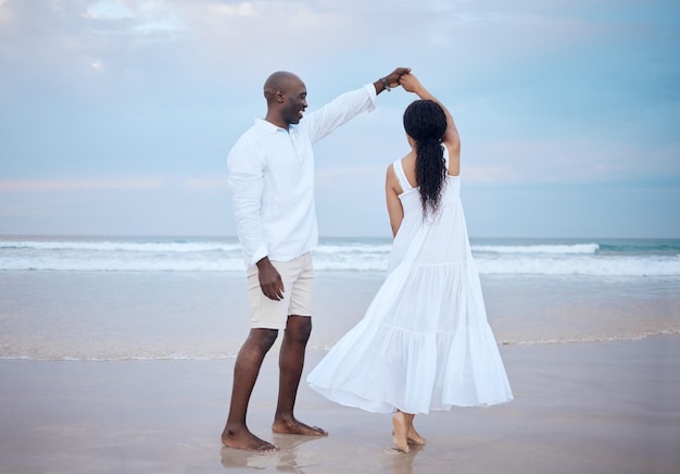 dancing honeymoon and black couple holding hands at beach for support trust or travel together on date smile sea and people romantic anniversary for holiday or marriage commitment in mauritius