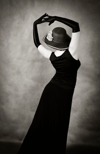 Dancing woman in a hat and long gloves