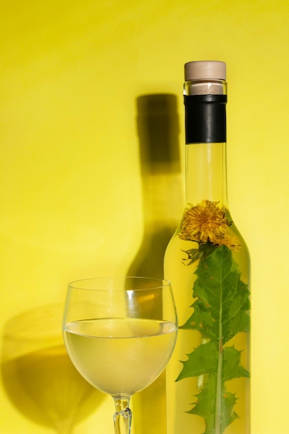 Dandelion wine on a yellow background