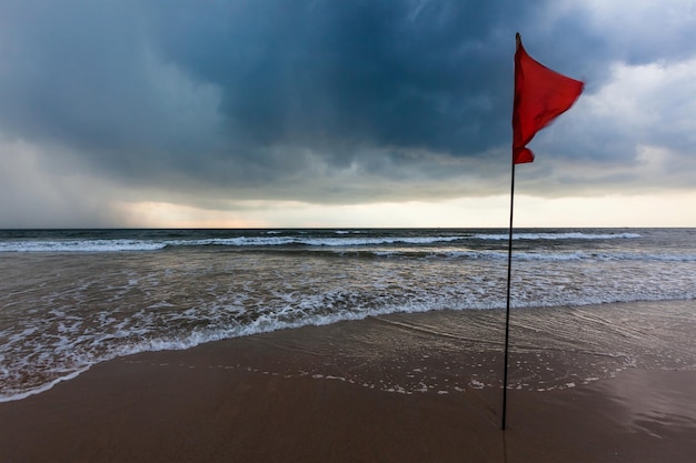 Danger concept background severe storm warning flags on beach Baga Goa India