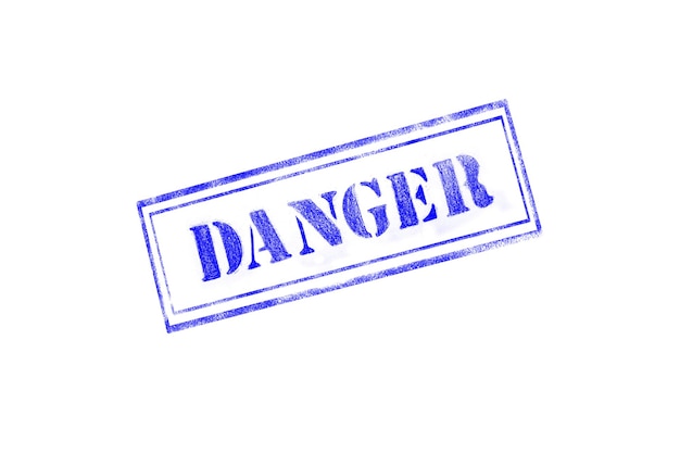 Photo danger texturised rubber stamp over isolated background