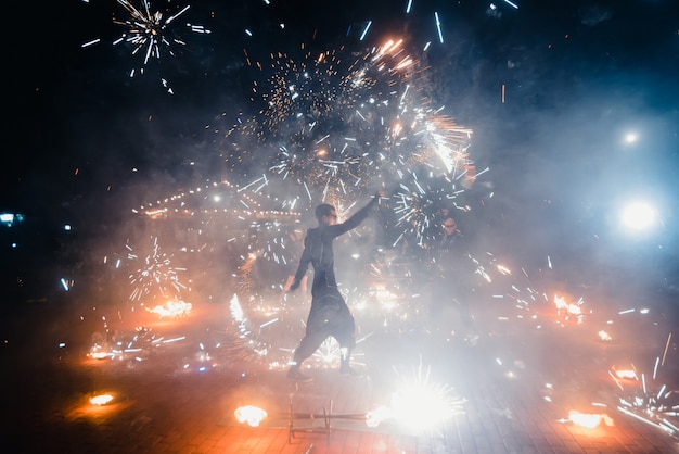 Dangerous fire show from the team of professional performers with burning torches