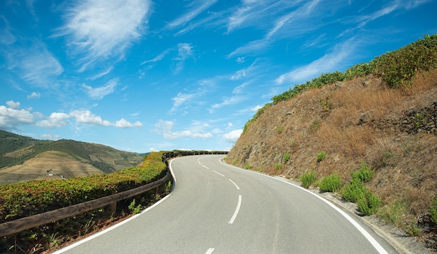 Dangerous sloping road with broken line