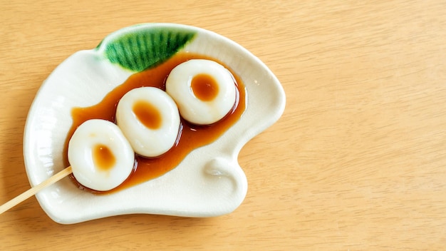 Dango Japanese dessert on a wooden table