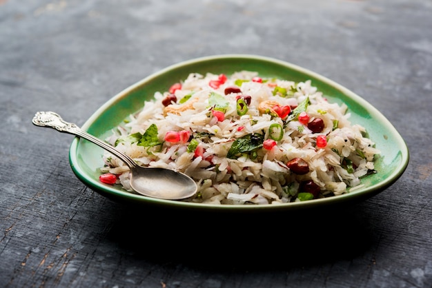 Dapde Pohe is a typical Maharashtrian breakfast, made with thin variety of poha and fresh coconut with chilli, peanuts and nuts. served in a bowl or plate. selective focus