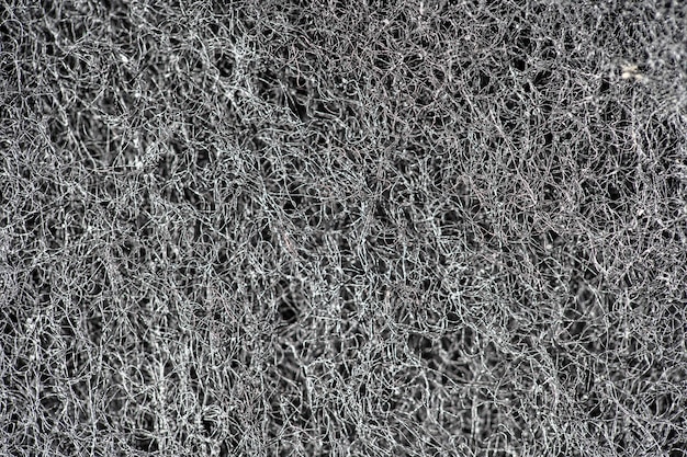 Photo dark abstract background and pattern of interwoven hairs, fibers and nanofibers. sponge detail texture, sponge texture close up background. cellulose sponge texture. black and white