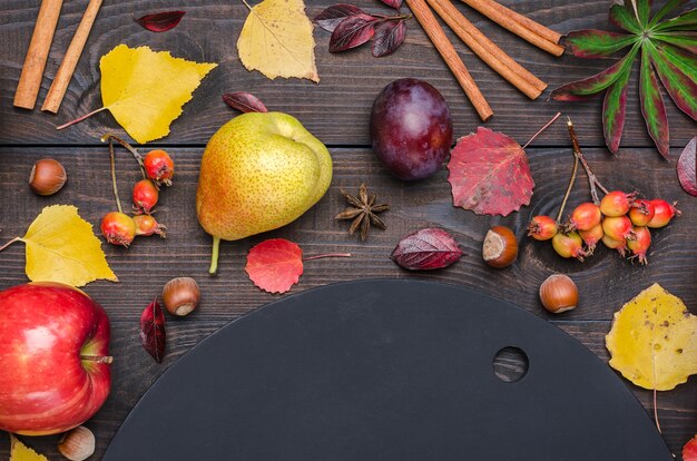 Dark autumn background with chalk board. Flat lay.