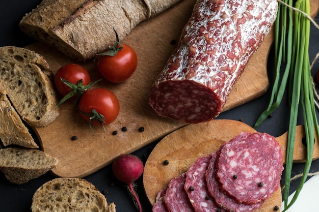 Dark background with bread and sausage pieces