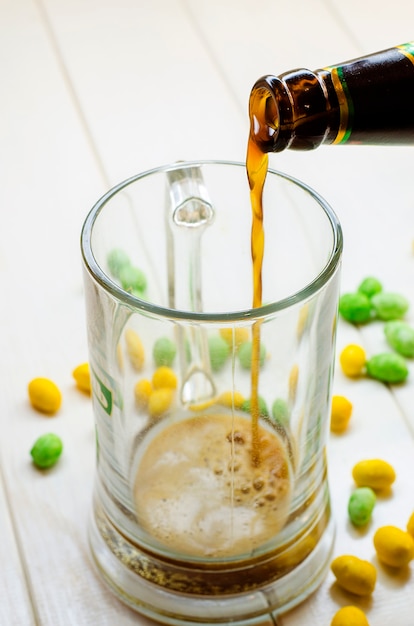 Dark beer pouring into a glass bottle