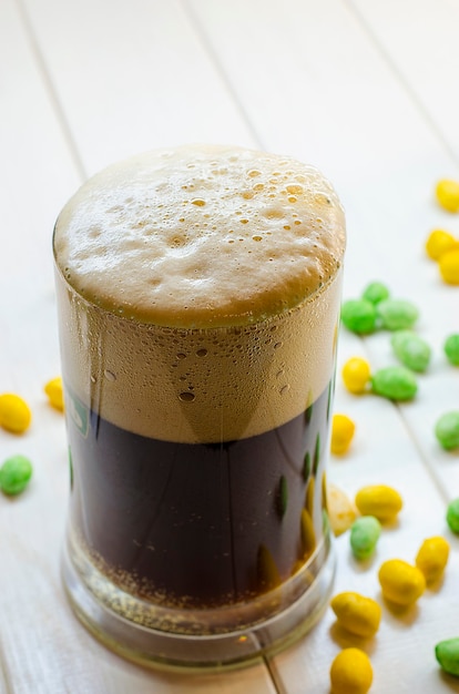 Dark beer pouring into a glass bottle